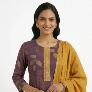 Woman wearing a purple printed kurta set with mustard dupatta and ethnic accessories